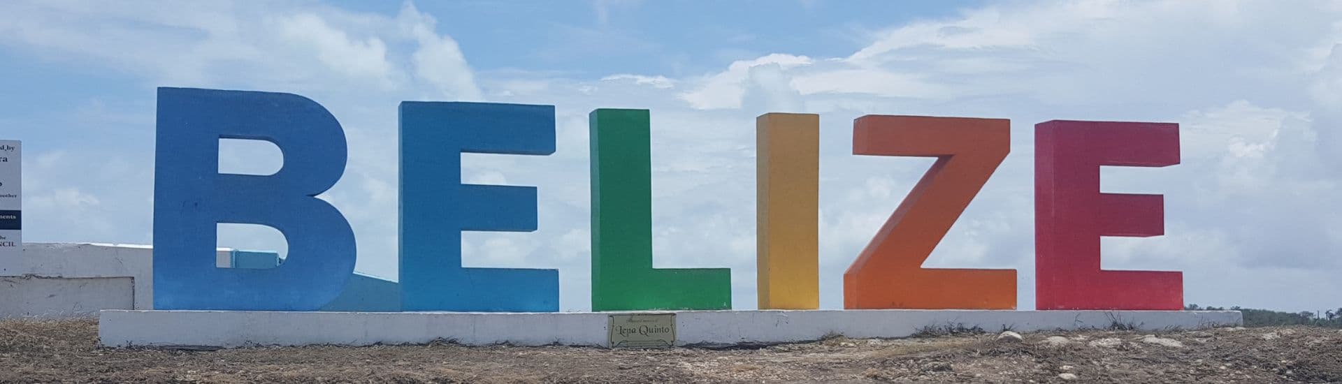 Colorful "BELIZE" letters against a blue sky.